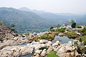 Local tribal women gather near the 322 feet Hundru waterfall to feast Shiva, the Supreme being in Hindu Shaivism, and beseech health and strength for their menfolk, Ranchi, Jharkhand, India, Asia