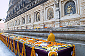 Flower offerings and a monk at the Buddhist Mahabodhi Mahabihara Temple (Great Stupa), Bodh Gaya, UNESCO World Heritage Site, Bihar, India, Asia