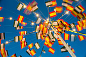 Colorful flags and lights during the traditional fair in Fuenteheridos, Huelva, Andalucia, Spain showcasing festive spirit and local culture.