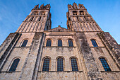 The historic Men’s Abbey in Caen showcases Gothic spires against a serene sky.