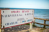 A vintage sign at Omaha Beach in Normandy, France, highlighting its historical significance from June 6, 1944.