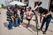 Community looking through telescope for the 2024 eclipse in Mapimi, Mexico.