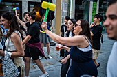 Greeting people with wilting leek and plastic hammers during Festival of St John of Porto (Festa de São João do Porto ) during Midsummer, on the night of 23 June (Saint John's Eve), in the city of Porto, Portugal