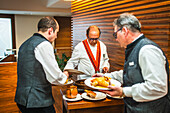 The famous chef Jose Maria Ruiz serves a traditional cochinillo asado at his restaurant in Segovia, Spain, showcasing local culinary traditions.