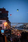 Hot air balloons launching over Luis I bridge and Douro River during Festival of St John of Porto (Festa de São João do Porto ) during Midsummer, on the night of 23 June (Saint John's Eve), in the city of Porto, Portugal