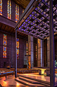 Interior of St. Joseph’s Church in Le Havre, showcasing Auguste Perret’s modernist design with vibrant stained glass.