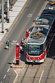 Pedestrians boarding the tram, view from above, Prague, Czech Republic