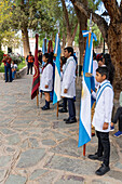 Youth groups in the town plaza for a festival on Saint Joseph's Day in Cachi, Argentina.