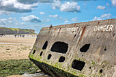 Remains of the historic Mulberry B at Gold Beach in Arromanches, Normandy, France, showcasing D-Day legacy.