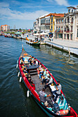 Boat ride through canals in a colorful and traditional Moliceiro boat, Aveiro, Portugal