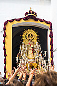 Faithful acclaim the Virgin del Rosario at the end of a procession in Carrión de los Céspedes, Seville, Spain.