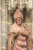 A detailed view of the terracotta statue of San Leandro by Mercadante de Bretaña (15th century), located at the Baptism Gate in Seville Cathedral, Spain.