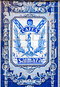 Intricate glazed ceramic tiles on the wall of the historic former Saimaza coffee factory in Seville, Spain. Beautiful craftsmanship and rich history captured in blue and white tiles.