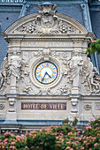 Detailed facade of Hotel De Ville in Vannes, Brittany, France, showcasing ornate architecture with a prominent clock.