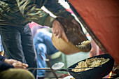 Close-up of traditional migas serranas being prepared in Villaviciosa de Córdoba, Andalucía, Spain. Captures the essence of Spanish culinary heritage and community gatherings.