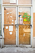 Chain and padlock on boarded up door