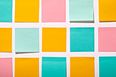 Rows of colorful blank adhesive notes on white background