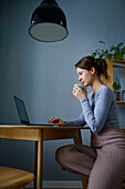 Woman using laptop at home