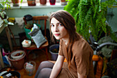 Portrait of pensive woman in living room