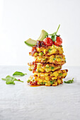 Curried corn cakes with bacon jam and avocado