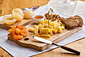 Cheese platter with fruit, nuts and honey