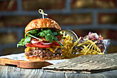 Bacon cheeseburger with red cabbage salad and French fries