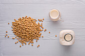 Soybeans and soy milk in jug and bottle