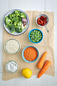 Ingredients for lentil and rice curry with broccoli and peas