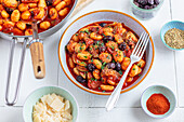 Gnocchi with tomato sauce, zucchini and olives