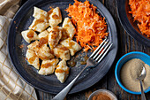 Curd cheese dumplings (Leniwe) with carrot and apple salad