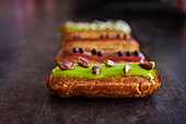 Eclairs with pistachio and chocolate icing