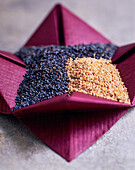 Black and light poppy seeds in a bowl