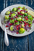 Brussels sprout salad with pomegranate seeds and sprouts