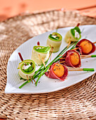 Courgette rolls with cream cheese and duck breast with melon