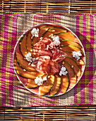 Melon with Parma ham, goat's cheese and pine nuts