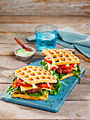 Potato waffle burger with meatballs, bacon and cheese
