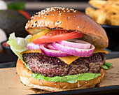 Cheeseburger with onion, tomato, gherkin and lettuce