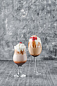 Two iced coffees with cream and cherries as decoration