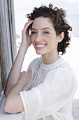 Brunette woman in cream-coloured blouse