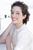 Brunette woman in cream-coloured blouse