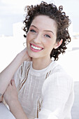 Brunette woman in cream-coloured blouse