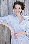 Young woman in light-blue shirt dress