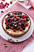 Berry tart with vanilla cream and pistachios