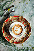 Cappuccino with decorative bear motif on milk foam