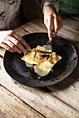 Raviolo with egg yolk and melted butter