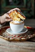 Pastry with cappuccino in the background