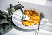 Potato pancakes with sour cream sauce and fresh dill