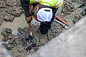 Worker replacing lead water pipes