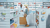 Pharmacist selling medicine to female customer