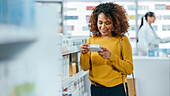 Woman choosing medication in pharmacy